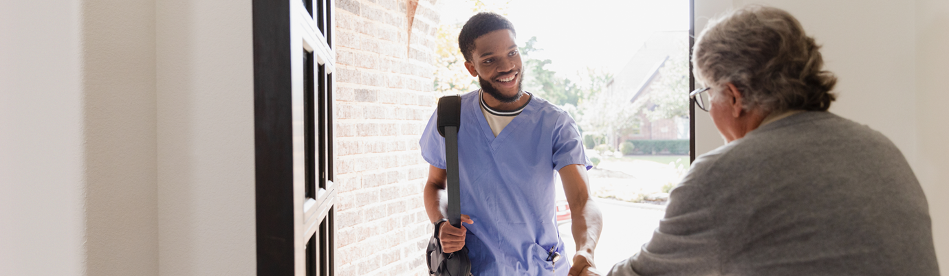 Health care worker greeting a patient at their home