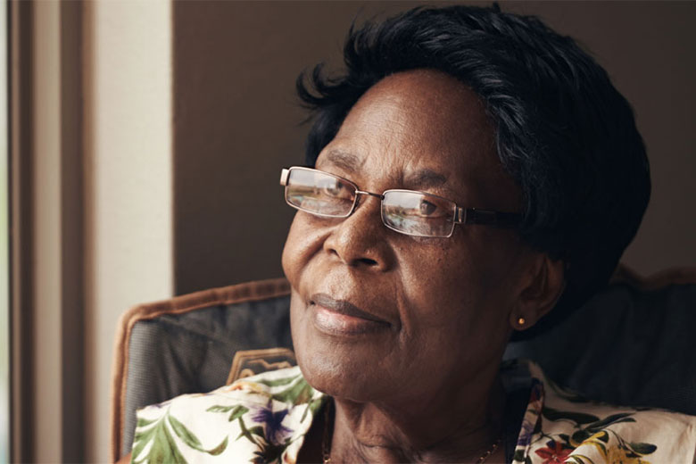 Elderly woman staring out of a window