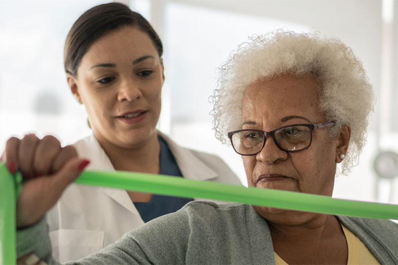 elderly woman getting physical therapy