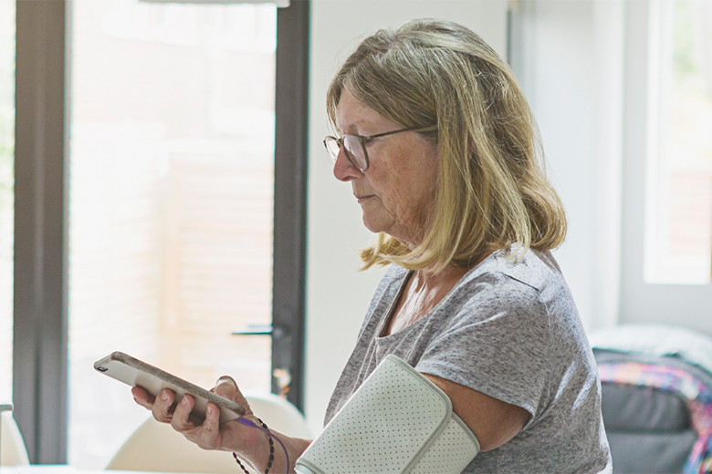 Woman using her phone to monitor her health