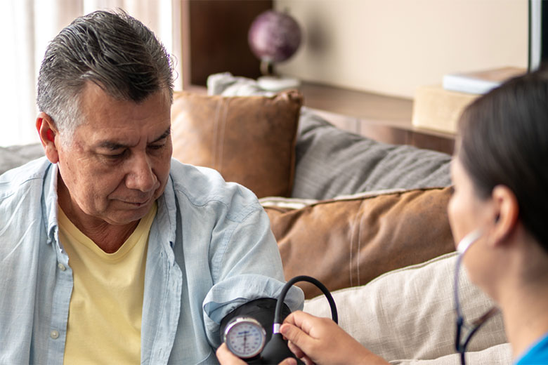 Nurse taking a male patient's blood pressure