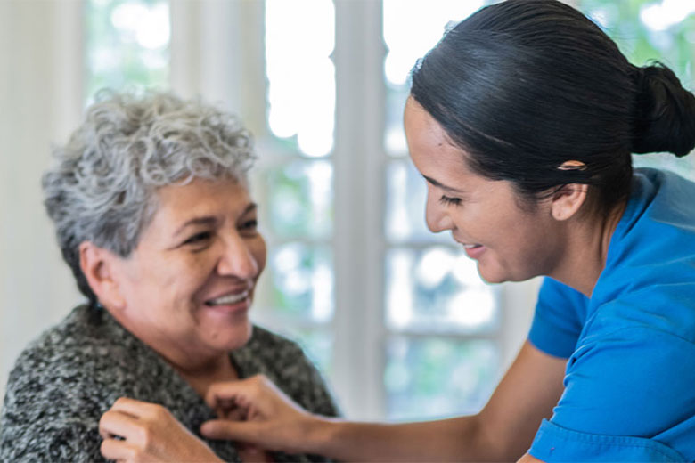 Health care worker helping elderly lady